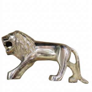 A side-profile photograph of a polished, vintage solid brass lion figurine in a walking, roaring pose, isolated on a plain white background