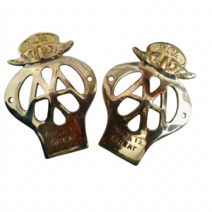 "A pair of polished brass custom motorcycle front fender badges featuring an ornamental wing and helmet design at the top, and embossed with the text 'INDIA IS GREAT' on the bottom curve. Isolated on a plain white background."